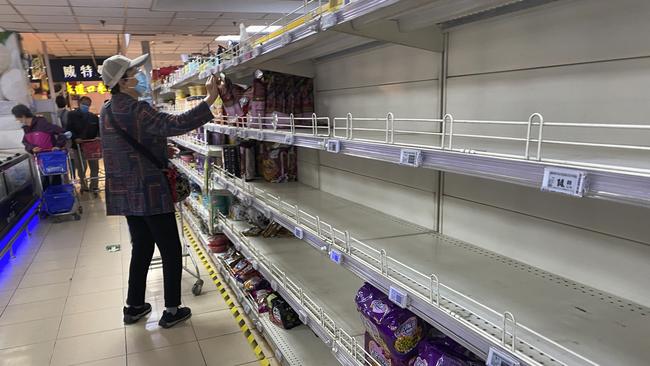 Shoppers empty shelves at a supermarket in Chaoyang District, Beijing. Picture: Getty Images