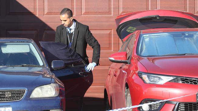 Police search a blue Lexus and red Toyota Corolla hatchback. Picture: David Crosling