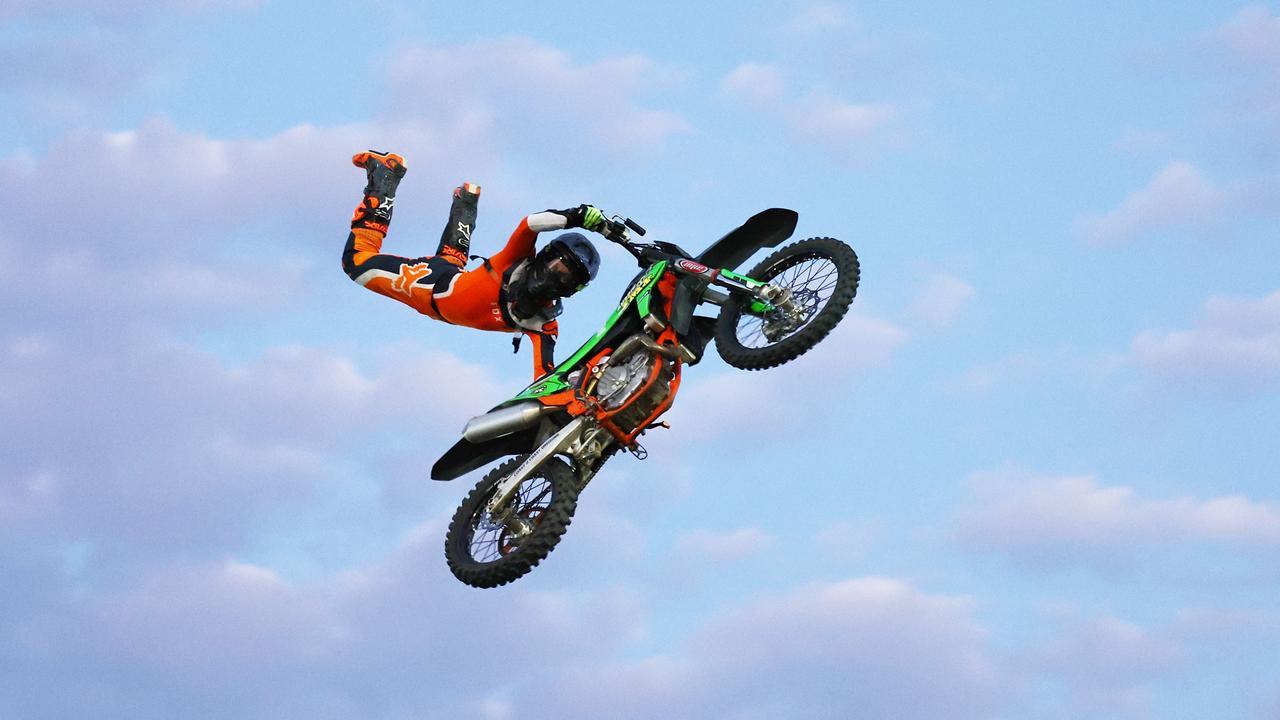 Brodie Karmichael Supermans over his motocross bike at the 2024 Cairns Bull Throttle event, a bikes and bulls show, featuring bull riding and freestyle motocross riders at the Cairns Showgrounds. Picture: Brendan Radke