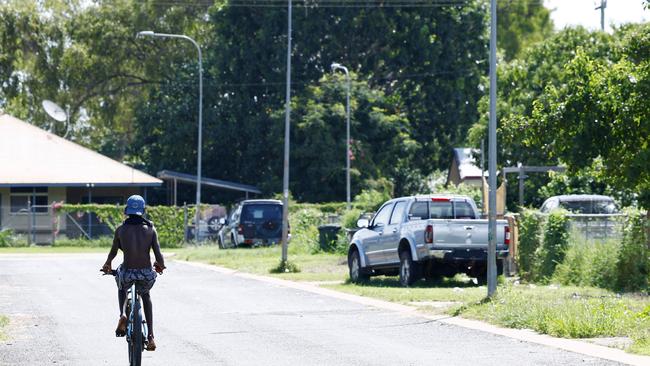 A man rides his bike along the street in Aurukun, a small indigenous town located on the Gulf of Carpentaria, 800km northwest of Cairns. Picture: Brendan Radke