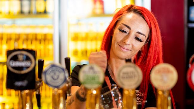 Emily Hazrati serves the <i>NT News </i>a pint of beer at Shenanigans, Darwin on the day that pubs reopened after the COVID shutdown last year. Picture: Che Chorley