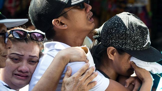 Family mourn the loss of Michael Siaron at a cemetery in Manila. Siaron was killed by suspected vigilantes on July 22 acting on President Rodrigo Duterte's call to kill all the country's drug dealers. Picture: Noel Celis/AFP