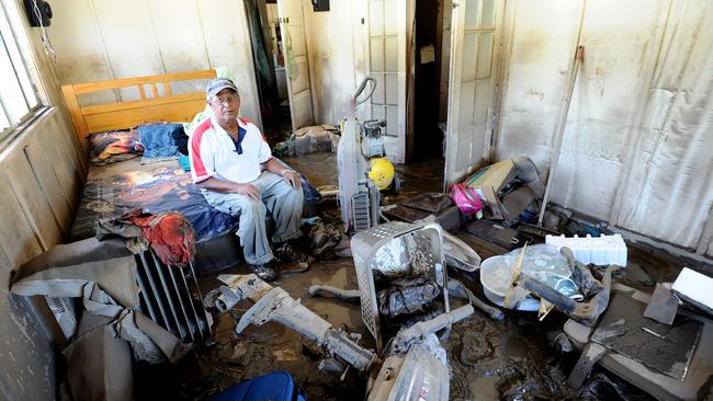 Residents inspect damage caused by floods in North Bundaberg. Picture: AAP/Paul Beutel