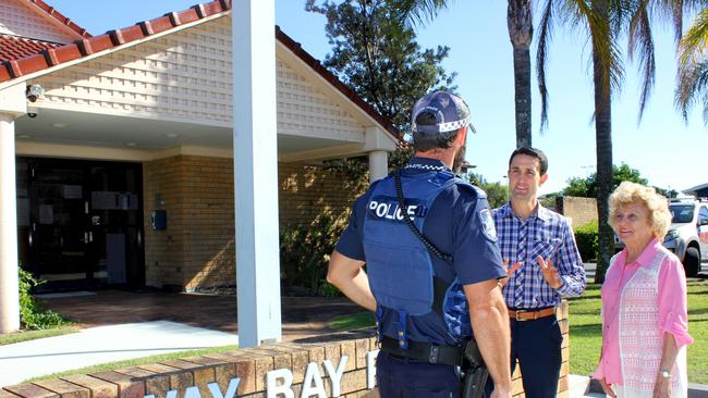 LNP Broadwater candidate David Crisafulli and resident Betty Robinson talking to a police officer at the Runaway Bay Police Station.