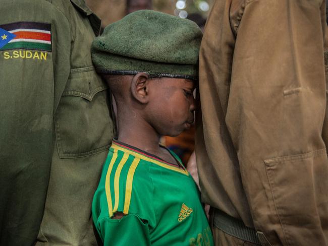 Newly released child soldiers wait in a line for their registration during the release ceremony in Yambio. Picture: AFP PHOTO/Stefanie Glinski