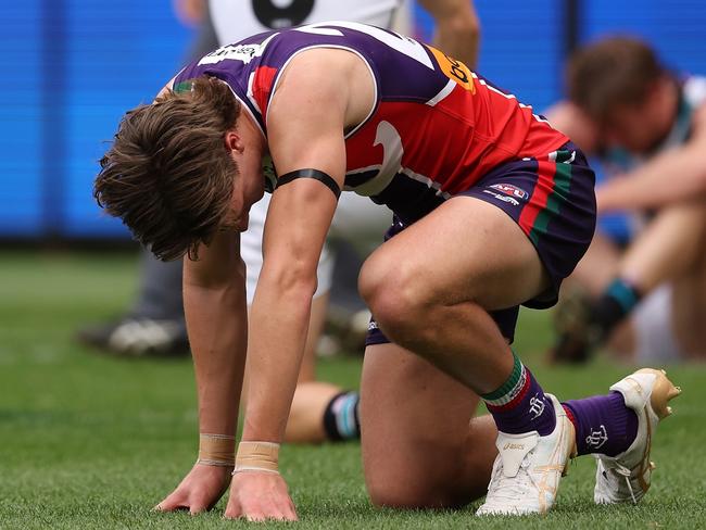 PERTH, AUSTRALIA - AUGUST 20: Aliir Aliir, Kane Farrell and Tom Jonas of the Power and Jye Amiss of the Dockers take a moment after a collision on the goal line during the round 23 AFL match between Fremantle Dockers and Port Adelaide Power at Optus Stadium, on August 20, 2023, in Perth, Australia. (Photo by Paul Kane/Getty Images)