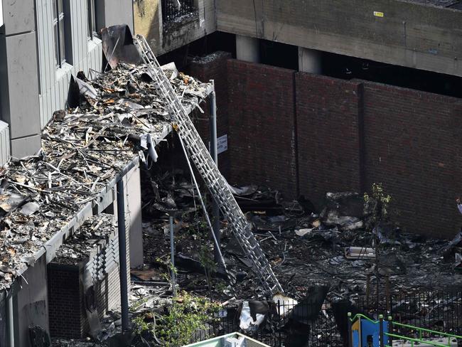 Firemen inspect the remains of Grenfell Tower. Picture: AFP