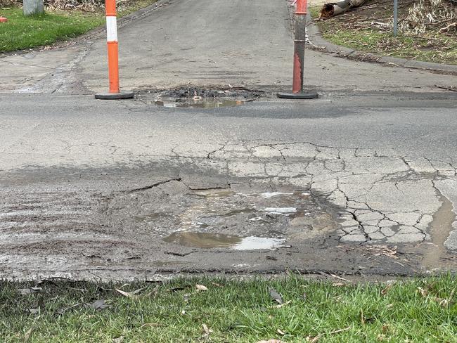 Fresh potholes that sink deeper when driven over have appeared in Coburn Ave above the McCrae landslide hot zone. Picture: Lucy Callander