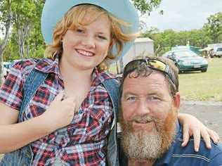 Sophie and dad Paul Raymond enjoy the country music at the Bundy Easter Round-up.