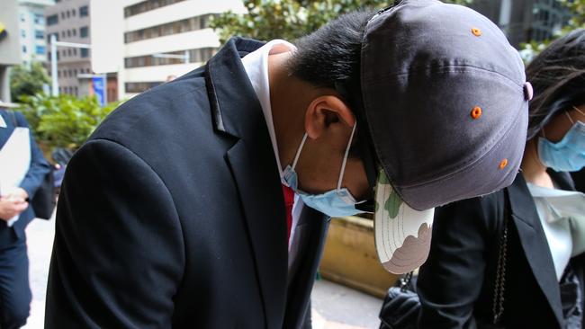 SYDNEY, AUSTRALIA - Newswire Photos -November 08, 2022; Dennis Su (wearing the red tie), is seen leaving the Downing centre Court in Sydney. Su intends to plead guilty over his role in a text scam that demanded money from dozens of Optus customers whose data was leaked online following the massive hack. Picture: NCA Newswire / Gaye Gerard