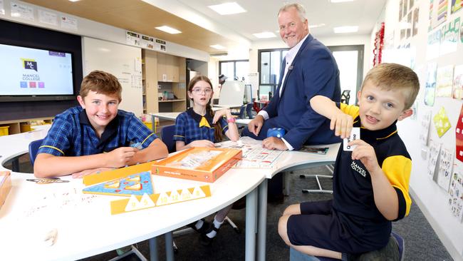 Mancel College principal Peter Foster with pupils (left to right) Khayden, 12, Maddie, 12, and Alex, 6, in one of their newly-constructed classrooms. Photo: Steve Pohlner.