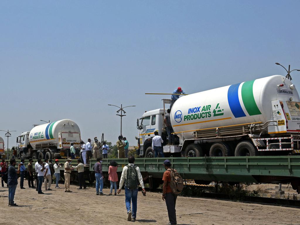 Oxygen tankers are boarded on a special 'Oxygen Express' train bound for the needy states at a goods yard in Navi, Mumbai, this week.