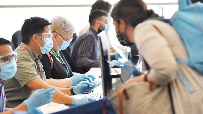 =Inbound travellers check in through quarantine at Adelaide Airport after new border restrictions came into place. Picture: David Mariuz