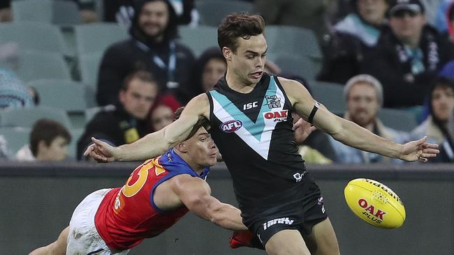 Karl Amon gets his kick away from Dayne Zorko. The rapid riser is keen to stay at the Power next year. Picture SARAH REED