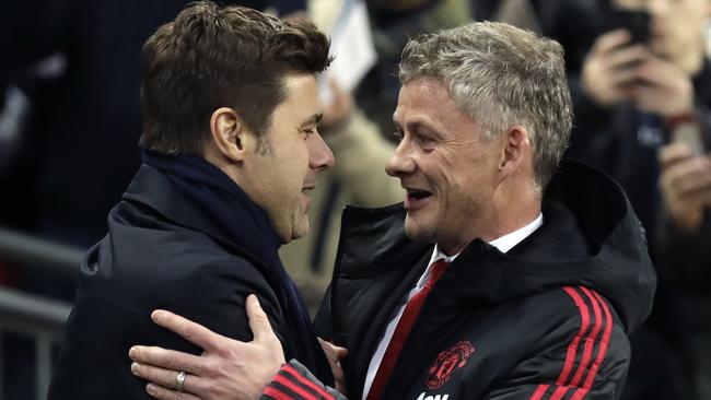 Manchester United caretaker manager Ole Gunnar Solskjaer, right, embraces Tottenham manager Mauricio Pochettino, left, at Wembley Stadium last week. Picture: AP
