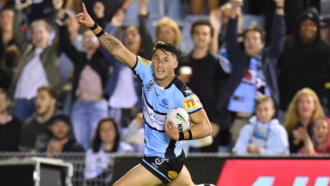 Bronson Xerri celebrates as he runs in to score a try for the Sharks. Picture: AAP