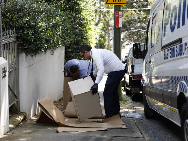 Police wrap furniture removed from the terrace. Picture: Richard Dobson