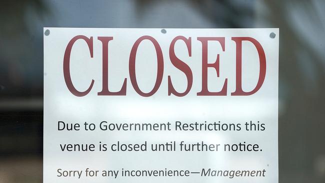 A closed sign is seen at Surfers Paradise business on the Gold Coast, Wednesday, April 8, 2020. The coronavirus has thrown small businesses into crisis, with many owners sending workers home as customers vanish. (AAP Image/Dave Hunt)