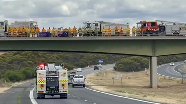 CFS volunteers formed a guard of honour to pay their respects to the CFS convoy. Picture: 7NEWS