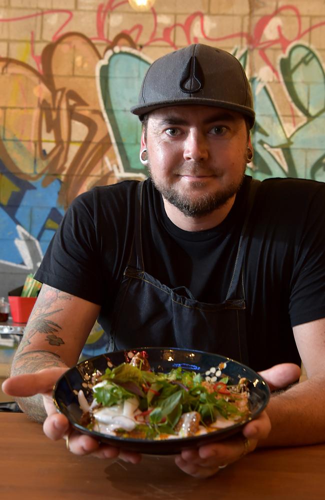 Head chef Mitch Smith serves up a plate of 10-hour braised coconut beef at Rice Boi.