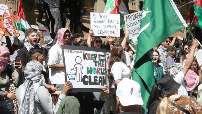 Anti-Israel signs are held at a Palestine rally in Melbourne’s CBD. Picture: NCA NewsWire / David Crosling