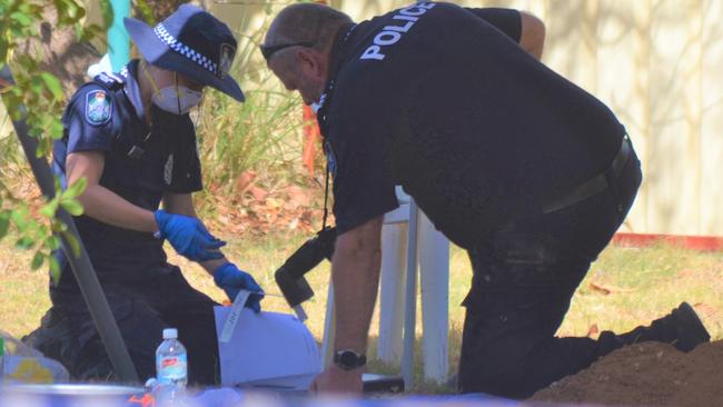 Police collect evidence from the backyard of a home in Chinchilla on the western Darling Downs.