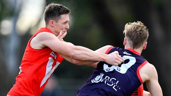 Daniel Helmore fights away from a Sean Downie tackle. (Photo by Josh Chadwick)