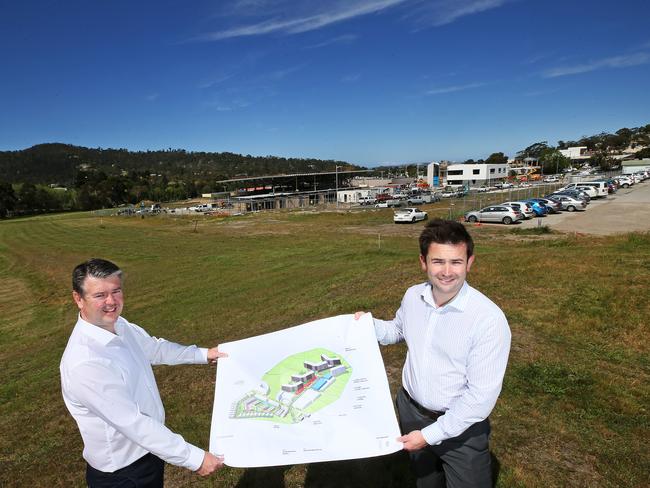 Traders In Purple CEO Brett Robinson, left, and Kingborough Mayor Dean Winter with the master plan for the Kingston Park development. Picture: CHRIS KIDD