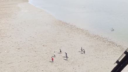 From the vantage point of a chopper, rangers observe a group of illegal fishermen walking along a beach near Maningrida. Picture: Supplied.