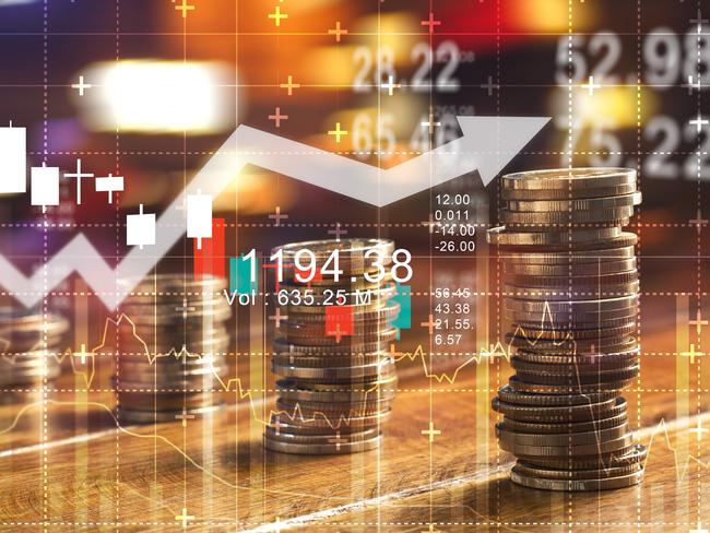 Finance and business concept. Investment graph and rows growth and of coins on table