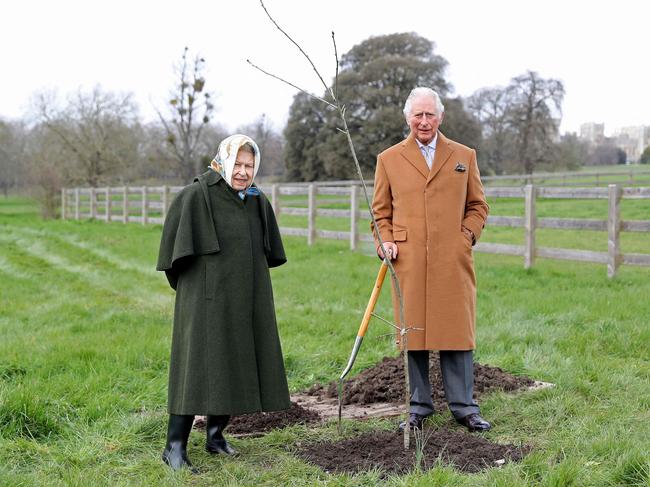 Queen Elizabeth II stands with her son Prince Charles in the grounds of Windsor Castle, after Charles planted a tree to launch The Queen's Green Canopy tree-planting initiative. Picture: AFP