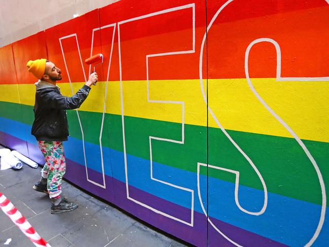 MELBOURNE, AUSTRALIA - AUGUST 27:  Artist David Pereirra paints a pro-gay marriage mural on a wall at Melbourne Central on August 27, 2017 in Melbourne, Australia. Artists are donating their time to paint walls donated by local businesses in support of marriage equality. The movement was inspired by anti-gay marriage graffiti around Melbourne as Australia prepares for postal vote on whether same-sex marriage should be legalised. The Australian Marriage Law Postal Survey is due to be sent out by the Australian Bureau of Statistics on September 12.  (Photo by Scott Barbour/Getty Images)