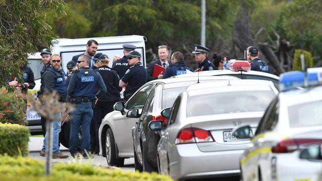 Police and detectives outside a West Lakes following a shooting on Friday. Picture: AAP/Mark Brake