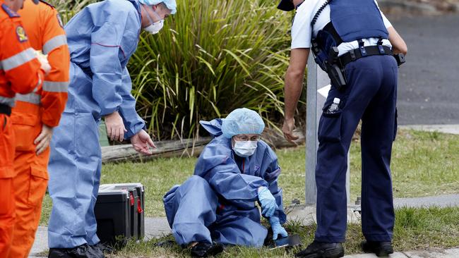 A forensic officer sweeps the scene of the shooting. Picture: Regi Varghese