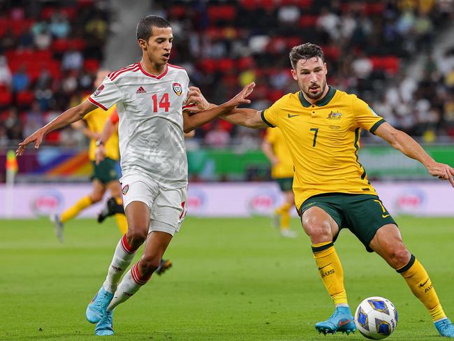 UAE midfielder Abdullah Hamad (left) challenges Socceroo Mathew Leckie. Picture: KARIM JAAFAR / AFP