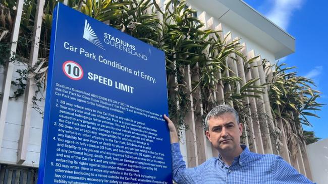 Parking around Robina Stadium on Titans game day is in chaos. Councillor Hermann Vorster stands outside the entrance to an unused Stadiums Queensland car park opposite the ground.