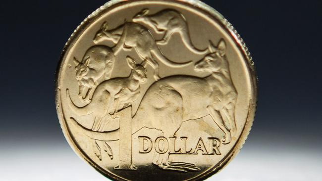An Australian one-dollar coin is arranged for a photograph in Sydney, Australia, on Wednesday, April 17, 2013. Direct trading between the Australian dollar and yuan started on April 10. Photographer: Ian Waldie/Bloomberg