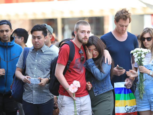 People showing their respects on the corner of Burke and Elizabeth st. Picture: Alex Coppel.