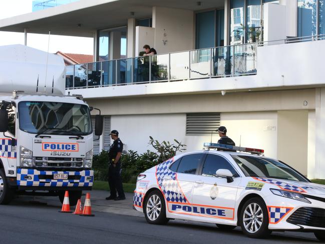 Police watched by residents at the scene of a suspected murder homocide at the Sapphire building at Labrador. Picture Glenn Hampson