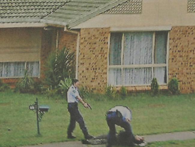 Police keep gun trained on Baladjam during his arrest in Green Valley, southwestern Sydney after he opened fire on them during a counter-terrorism raid. Picture: Supplied