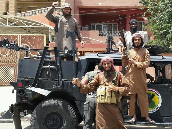 Australian fugitive Khaled Sharrouf (back left) who fled Australia to fight with Islamic extremist insurgents in Syria seen with other ISIS extremists.