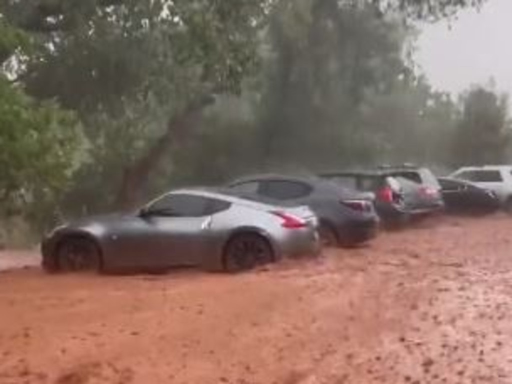 Sport cars were filmed being shoved towards a cliff by raging floodwater. Picture: TikTok/getagripgarage