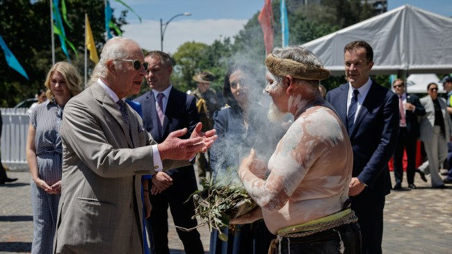 The monarch is welcomed to the community event with a smoking ceremony. Picture: Brook Mitchell/Getty Images