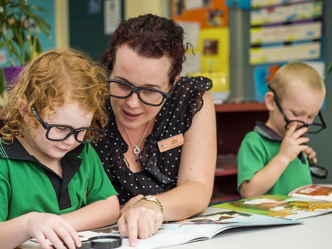 Berry Springs Preschool teacher Carla Hayes helps Ruby during class.