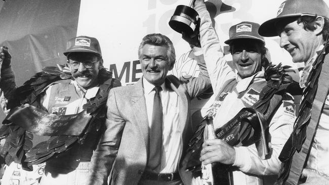 Peter Brock receives his Bathurst 1000 winners’ trophy from Prime Minister Bob Hawke with co-drivers Larry Perkins and John Harvey.