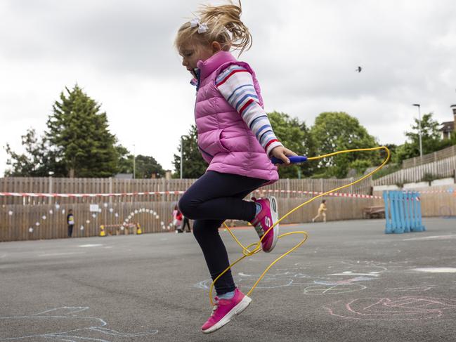 Children maintain social distancing measures as they play. Picture: Dan Kitwood