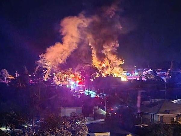 A Campbelltown service station has been engulfed in flames after the complex exploded overnight. Picture: Twitter