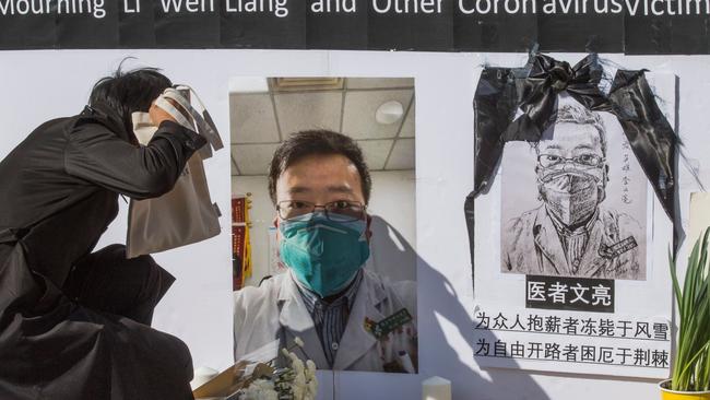 Chinese students hold a memorial for Dr Li Wenliang, the Wuhan whistleblower, outside the UCLA campus in California. Picture: AFP.