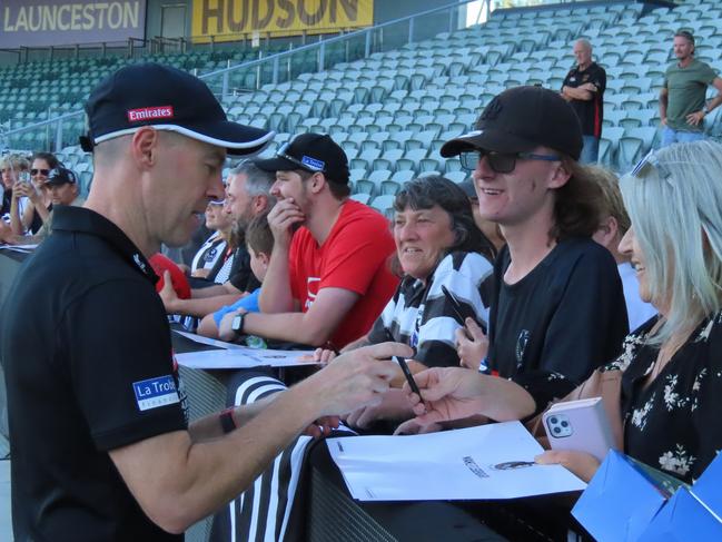 Collingwood coach Craig McRae signs autographs for fans. Picture: Jon Tuxworth