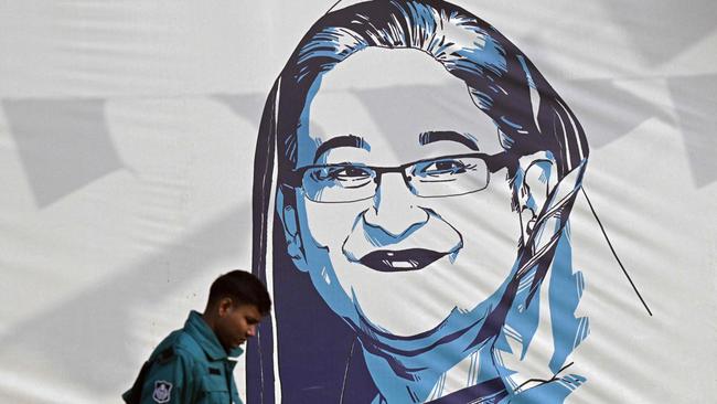 A policeman walks past a portrait of Bangladesh's Prime Minister Sheikh Hasina in Dhaka on January Sunday. Picture: AFP